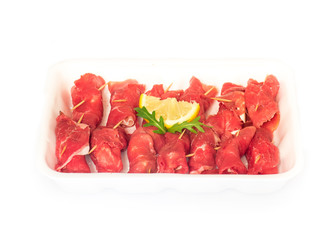 raw uncooked beef roulades on plastic market box