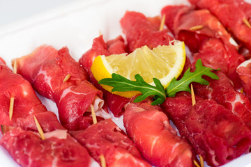 raw uncooked beef roulades on plastic market box