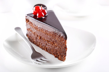 Delicious chocolate cake on plate on table on light background