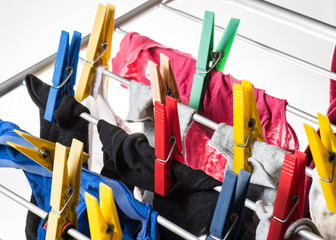 mixed  clean laundry pinned with colourful clothespins