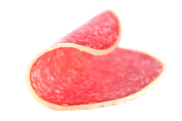 Slice of salami isolated on white background