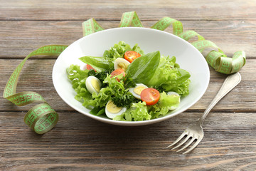 Salad with quail egg and basil in plate