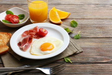 Bacon and eggs on rustic wooden planks background