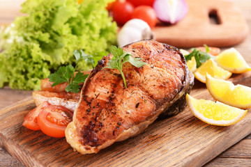 Tasty baked fish on table close-up