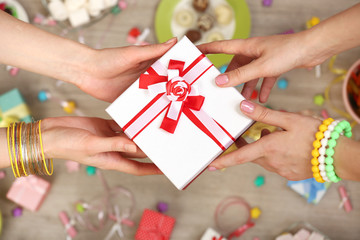 Female hands holding gift close-up