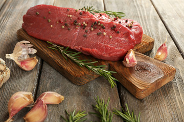 Raw beef steak with rosemary and garlic