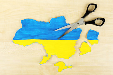 Map of Ukraine and scissors - concept of disintegration of the