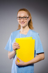 Young woman doctor with book