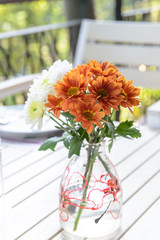 Flowers in glass vase on wood table
