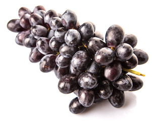 Black grapes over white background