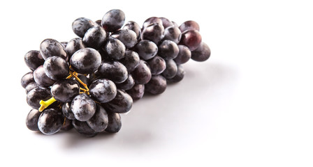 Black grapes over white background