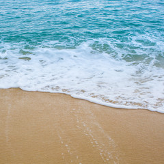 Surf wave is covering a sea beach sand