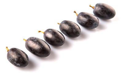 Black grapes over white background