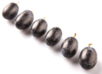 Black grapes over white background