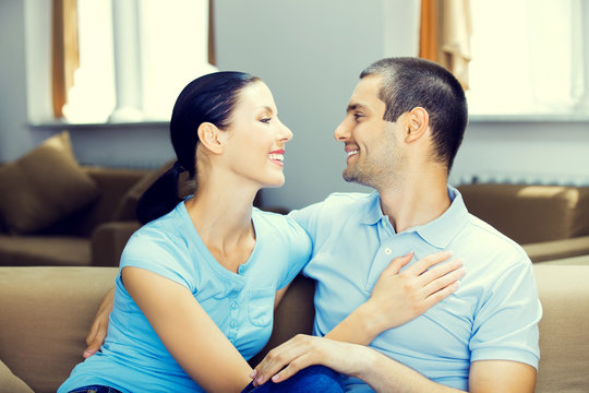 Cheerful smiling young attractive couple, indoors