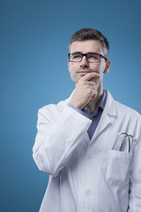 Pensive doctor with hand on chin
