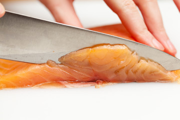 Cutting a piece of fish for sushi