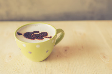 Love message on coffee cup on wooden background with vintage col