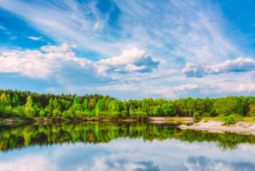 Obraz na płótnie Canvas Summer Forest And River Under Blue Sky