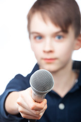 Boy holding microphone, focus on mic