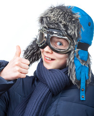 Boy in winter clothing showing thumb up