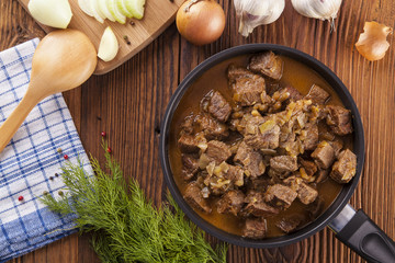 Beef stew - wooden background