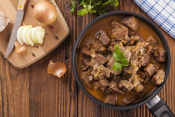 Beef stew - wooden background