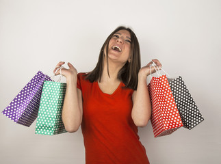 young girl with spotty shopping bags in studio