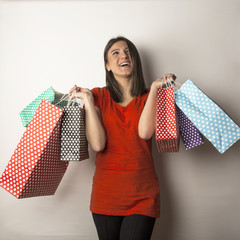 young girl with spotty shopping bags in studio