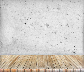 Backdrop sandstone wall and wood slabs arranged in perspective.