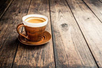Coffee cup on old wooden table