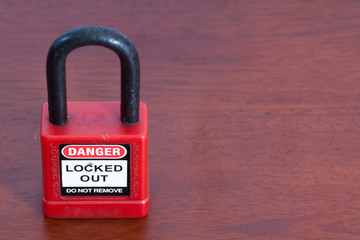 Lockout Padlock red color on wood background