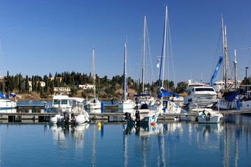 Fototapeta na wymiar Yachts and sail boats reflected in a Marina 