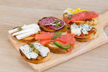 Tapas with cheese, salami and salmon