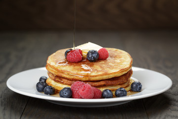 Classic pancakes with butter berrys and maple syrup