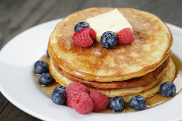 Classic pancakes with butter berrys and maple syrup