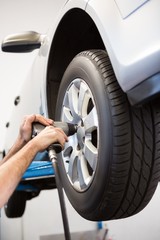 Fototapeta premium Mechanic adjusting the tire wheel
