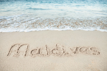 Maldives Written On Sand By Sea