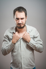 Young businessman with tie undone, making a silly face