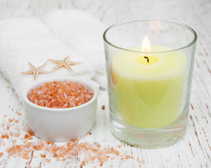 spa setting with  towels, candle and salt