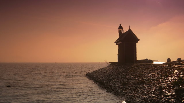 Beacon at the Ijsselmeer at sunset. Volendam, The Netherlands