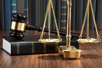 Gavel On Book With Golden Scale