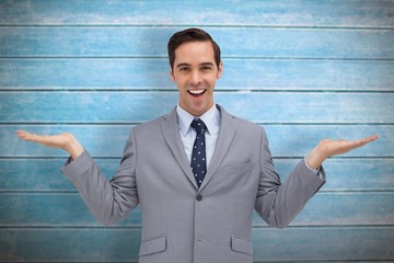 Smiling businessman presenting something with his hands