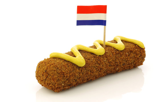 a Dutch snack called "kroket" with mustard and a Dutch flag