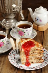 Russian bliny with raspberry jam, vintage samovar and teaware