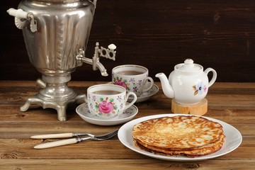 Russian bliny with vintage samovar and teaware