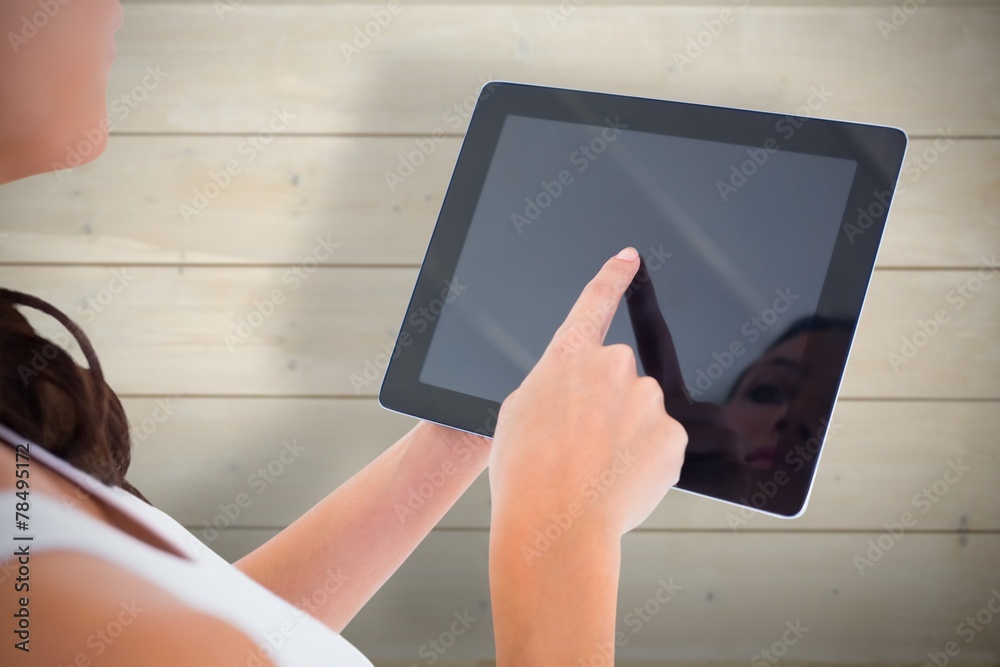Poster composite image of pretty brunette using tablet pc