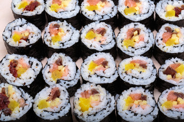 sushi fresh maki rolls isolated on wooden board