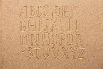 Spain alphabet  written on the sand