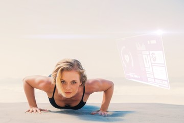 Composite image of fit blonde in plank position on the beach